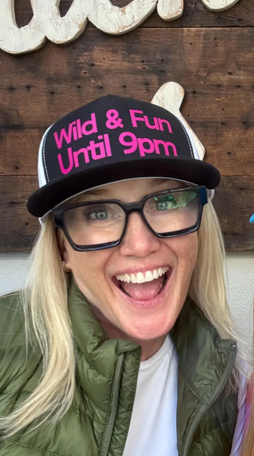 Midlifers. Wild and Fun black trucker with hot pink font.